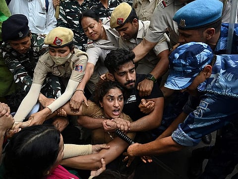 Indian wrestlers Vinesh Phogat (C) with others are detained by the police while attempting to march to India's new parliament during a protest against Brij Bhushan Singh, the wrestling federation chief, over allegations of sexual harassment in New Delhi on May 28, 2023