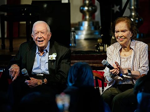 Former President Jimmy Carter and his wife former first lady Rosalynn Carter sit together during a reception to celebrate their 75th wedding anniversary on July 10, 2021, in Plains, Ga.