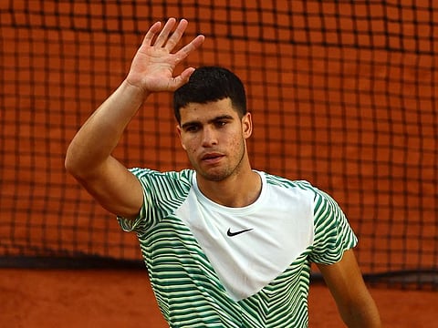 Spain's Carlos Alcaraz celebrates after winning his first round match against Italy's Flavio Cobolli.