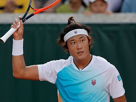 China's Zhang Zhizhen celebrates his victory over Serbia's Dusan Lajovic in their men's singles match on day two of the Roland-Garros Open tennis tournament in Paris.