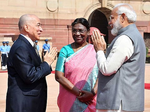 Prime Minister Narendra Modi and King Norodom Sihamoni of Cambodia greet each other as President Droupadi Murmu looks on during his ceremonial welcome at the forecourt of Rashtrapati Bhavan in New Delhi on Tuesday, May 30, 2023.