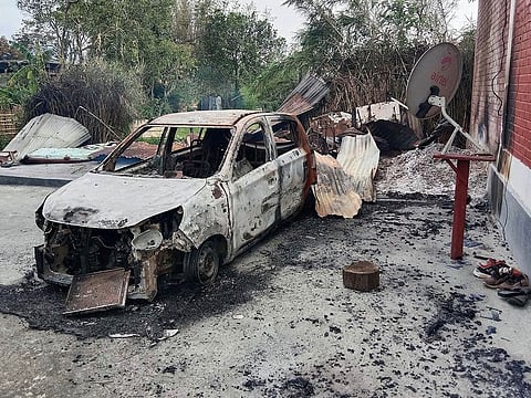 Charred remains of a car is seen in the violence-hit area of Manipur
