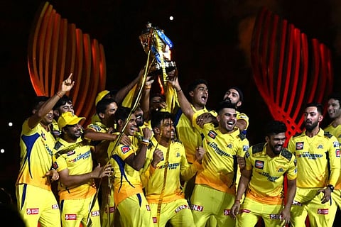 Chennai Super Kings' players celebrate with the trophy after defeating Gujarat Titans in the Indian Premier League final in Ahmedabad on Monday.