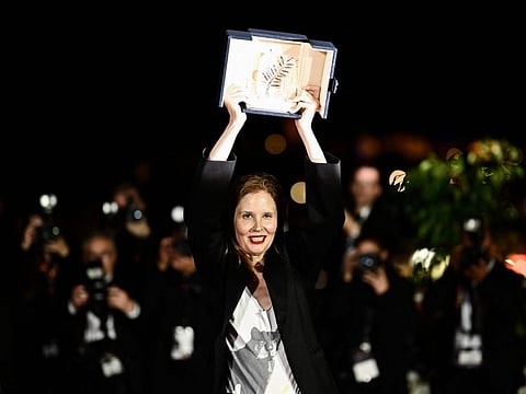 French director Justine Triet poses with her trophy during a photocall after she won the Palme d'Or for the film 'Anatomie d'une Chute' (Anatomy of a Fall) during the closing ceremony of the 76th edition of the Cannes Film Festival in Cannes, southern France, on May 27, 2023.