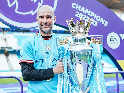 Smiling... Manchester City coach Pep Guardiola with the Premier League trophy. City stand to earn an incredible £270 million if they win the treble this season.