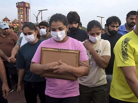 Sakshi Malik, an Indian wrestler who won a bronze medal at the 2016 Summer Olympics, leads a team of wrestlers towards the banks of the river Ganges in Haridwar, India, Tuesday, May 30, 2023.