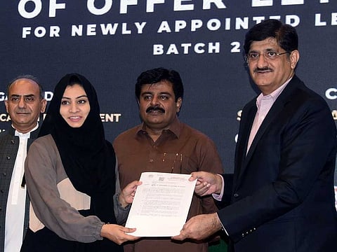 A newly recruited lecturer being handed her appointed letter by Sindh Chief Minister, Syed Murad Ali Shah.