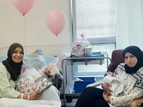 Sisters in a hospital in Umm Al Fahm in Israel have captured the hearts of many on social media. The image shows the new mother, Nidaa, cradling the baby, while Maimouna, the biological mother, holds a bouquet of flowers.