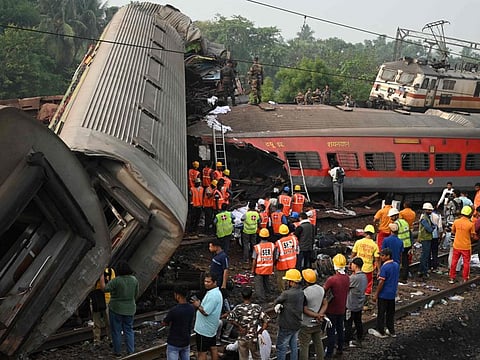 Rescue workers gather around damaged carriages at the accident site of a three-train collision near Balasore, about 200 km (125 miles) from the state capital Bhubaneswar in the eastern state of Odisha, on June 3, 2023.