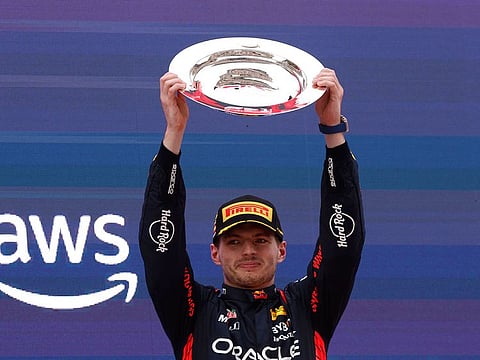 Red Bull's Max Verstappen celebrates with a trophy on the podium after winning the Spanish Grand Prix.