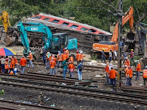 Heavy machinery remove damaged coaches from the railway tracks at the site of a train collision following the accident in Balasore district in the eastern state of Odisha, India, June 4, 2023.