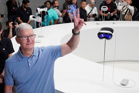 File photo: Apple CEO Tim Cook gestures next to Apple's Vision Pro headsets at Apple's annual Worldwide Developers Conference at the company's headquarters in Cupertino, California, U.S. June 5, 2023.