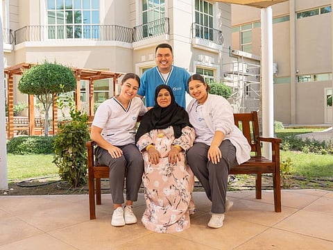 Mama Khatoun, an Emirati mum and former police officer, with medical caregivers who helped her get back on her feet.