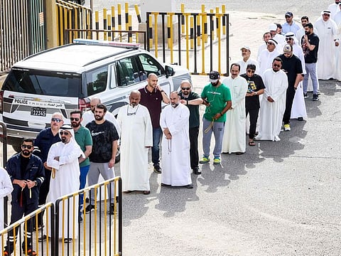 Voters at a polling station during parliamentary elections in Kuwait City on June 6, 2023.