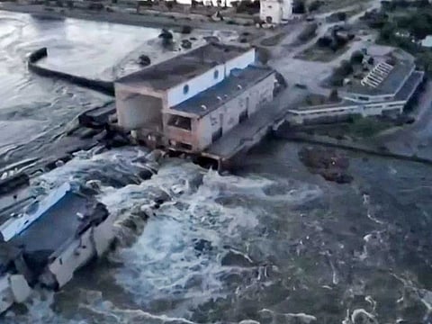 This screen grab from a video posted on Ukraine's President Volodymyr Zelensky's Twitter account on June 6, 2023 shows an aerial view of the dam of the Kakhovka Hydroelectric Power Station after it was partially destroyed.