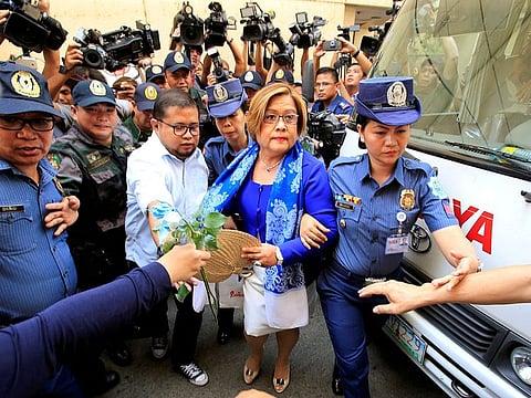 Philippine police escort Leila de Lima, a senator detained on drug charges, on her way to a local court to face an obstruction of justice complaint in Quezon city, metro Manila, Philippines March 13, 2017.