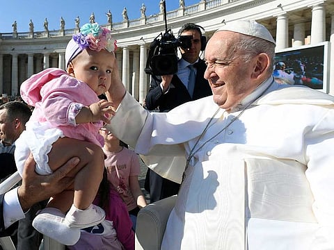 Pope Francis greets a child as he holds the weekly general audience in St. Peter's Square at the Vatican June 7, 2023.