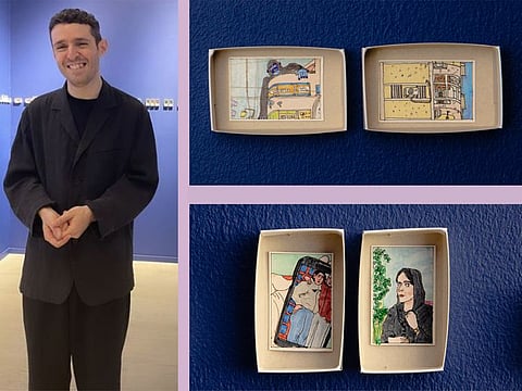 Artist Bady Dalloul with a section of his pocket matchbox artworks on display at The Third Line in Dubai.