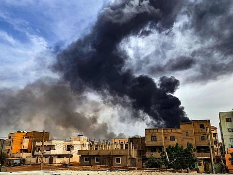 Smoke plumes billow from a fire at a lumber warehouse in southern Khartoum amidst ongoing fighting on June 7, 2023.
