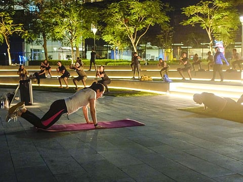 Members attend a fitness session of @ The Park (ATP) group at Dubai Internet City Amphitheatre.