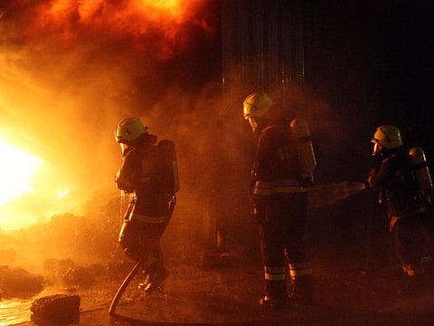 Firefighters try to clear the fire that broke out at a warehouse in Sharjah industrial area.