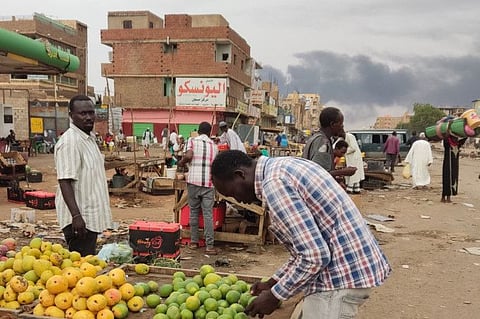 People gather at a market to buy food provisions in Khartoum on June 10, 2023.