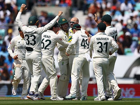 Australia's Nathan Lyon celebrates after taking the wicket of India's KS Bharat with teammates.
