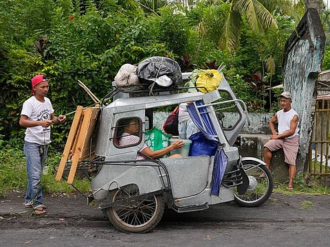 Residents living near Mayon Volcano in Daraga, Albay province, northeastern Philippines prepare to move to an evacuation center.