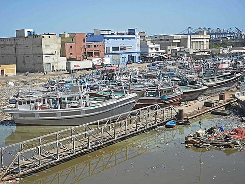 Fishing boats are anchored at a fishing harbour in Karachi on June 11, 2023. Heavy rains followed by strong winds killed at least 27 people, including eight children, in northwest Pakistan, officials said.