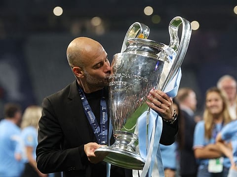 Manchester City manager Pep Guardiola kisses the trophy as he celebrates winning the Champions League on Saturday.