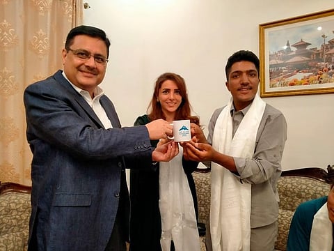 Ambassador of Nepal, Tapas Adhikari presenting a souvenir to the Pakistani mountaineers Sajid Ali Sadpara and Naila Kiani, at a reception to mark the 70th anniversary of the First Ascent of Mount Everest.