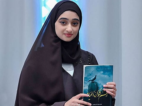 Hejoon Al Zeyoudi with her book titled Raghma Shaook Al Hayat (Despite the Thorns of Life).