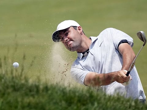 Scottie Scheffler hits from a bunker to the 17th green during a practice round of the US Open at Los Angeles Country Club on Monday.