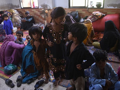 Children at a temporary shelter set up at a school in Badin district of Pakistan's Sindh province on June 14, 2023, ahead of cyclone Biporjoy landfall.