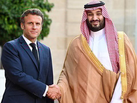 France's President Emmanuel Macron greets Saudi Crown Prince Mohammad bin Salman as he arrives at presidential Elysee Palace in Paris on July 28, 2022.