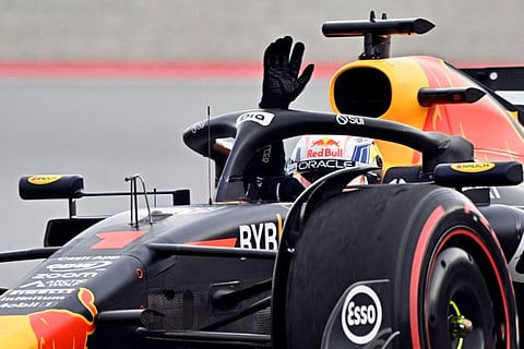 Red Bull's Dutch driver Max Verstappen reacts waving after crossing the finish line in first place during the Spanish Grand Prix race at the Circuit de Catalunya in Montmelo on June 4.