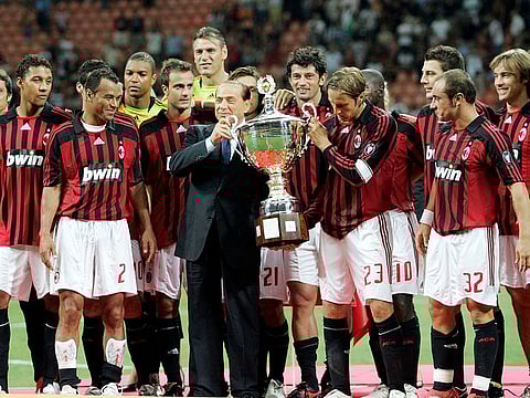 FILE - AC Milan president Silvio Berlusconi, center in dark suit, celebrates with the team after defeating Juventus to win the Luigi Berlusconi Trophy exhibition soccer match at the San Siro stadium in Milan, Italy, on Aug. 17, 2007.