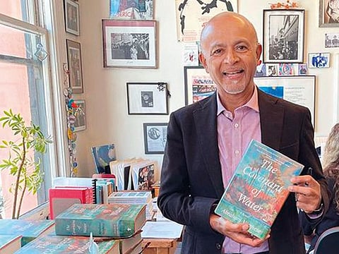 Dr Abraham Verghese with his bestseller The Covenant of Water