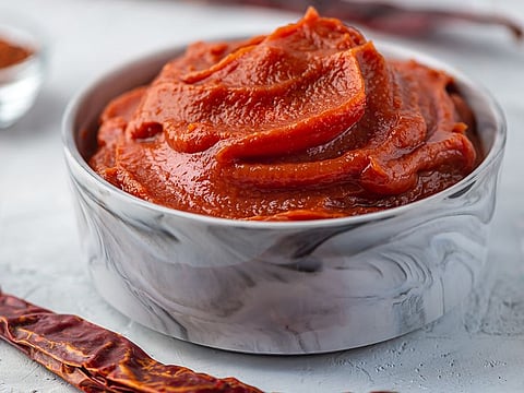 Gochujang is a biting crimson paste that is indispensable to Korean cuisine. The word itself is self-explanatory, as ‘gochu’ means a special kind of chilli pepper, and ‘jang’ means paste. It brings flavour to different Korean dishes, including salads, stews and curries. It elevates the taste of the dish.