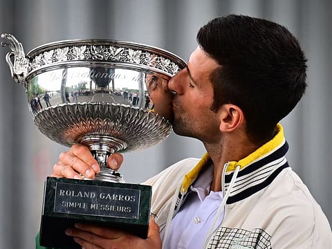 Serbia's Novak Djokovic kisses the Musketeers' Trophy during a photocall after winning the French Open.