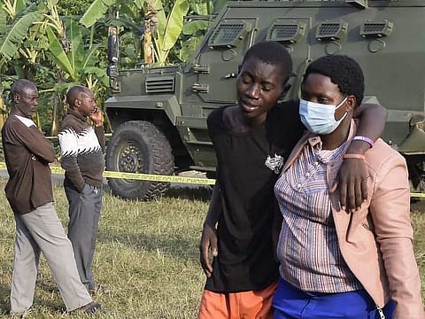 A boy is comforted at the scene of an attack in Mpondwe, Uganda, on June 17, 2023 at the Mpondwe Lhubiriha Secondary School.