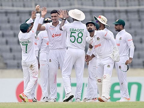 Bangladesh's Taskin Ahmed (2L) celebrates with teammates after the dismissal of Afghanistan's Rahmat Shah (not pictured) during the fourth day of the Test match at the Sher-e-Bangla National Cricket Stadium in Dhaka on June 17, 2023.