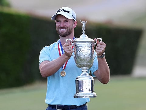 Wyndham Clark celebrates with the championship trophy after winning the US Open at Los Angeles Country Club.