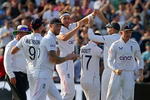 England's Stuart Broad (centre) celebrates with teammates after taking the wicket of Australia's Steve Smith on day four of the first Ashes Test match on Monday.