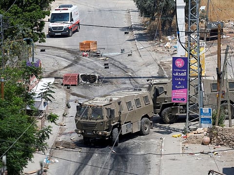 Israeli military vehicles drive during an Israeli raid in Jenin, in the West Bank June 19, 2023.