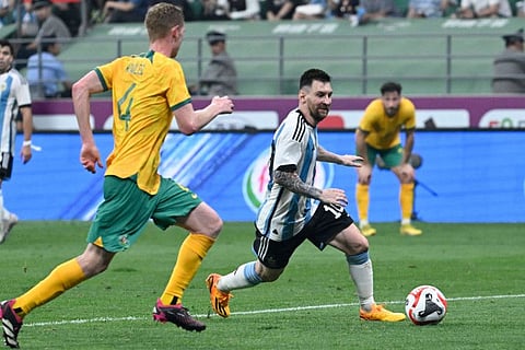 Argentina's Lionel Messi vies for the ball with Australia's Aziz Behich during a friendly match at the Workers' Stadium in Beijing on June 15.