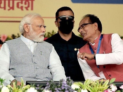 Prime Minister Narendra Modi interacts with Madhya Pradesh Chief Minister Shivraj Singh Chauhan during National Panchayati Raj Divas celebrations in Rewa, Madhya Pradesh, India