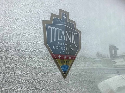 The logo for an OceanGate Expeditions 2019 Titanic expedition is seen on a marine industrial warehouse office door in Everett, Wash., Tuesday, June 20, 2023.