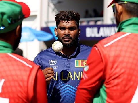 Sri Lankan spinner Wanindu Hasaranga speaks with Oman players after winning the World Cup Qualifier match on Friday.