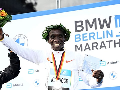 Kenya's Eliud Kipchoge celebrate on the podium after the Berlin Marathon race in September last year.